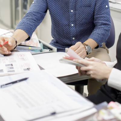 写真：社内でスタッフと打ち合わせをする田中さんの手元